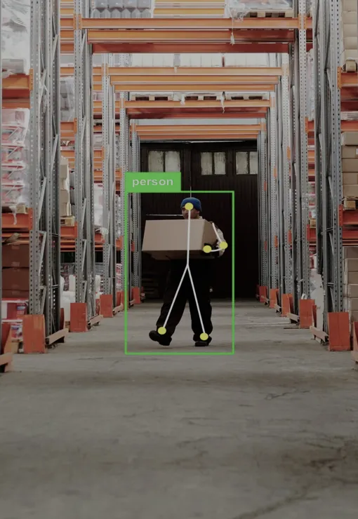 AI person detection with a worker carrying a carton in a warehouse aisle